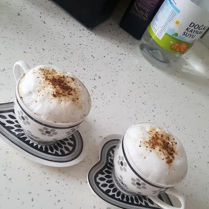Bol köpüklü, tarçın serpilmiş iki fincan Türk kahvesi